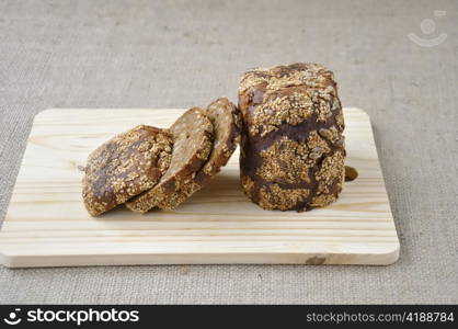Rye bread with cereals cut pieces on a wooden board