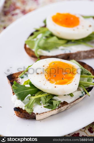 Rye toast sandwiches with egg and soft cheese, selective focus