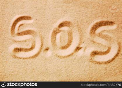S.O.S. written in golden sand - distress message