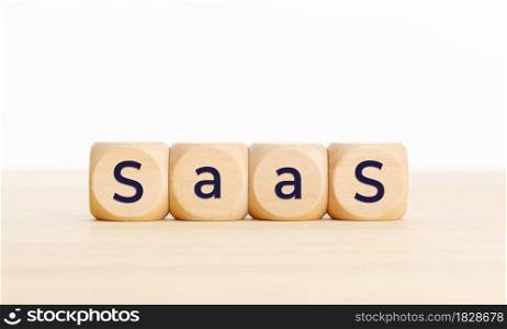 Saas word on wooden blocks on table. Copy space