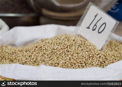 Sack of coriander seeds for sale at the market with price label
