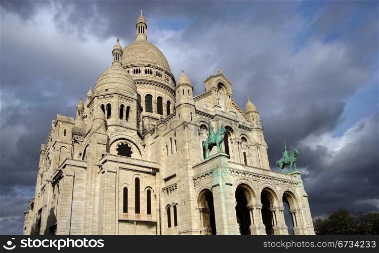 Sacre Coeur in Paris, France, as storm clouds gather.