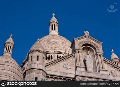 Sacre Couer in sunlight against blue sky