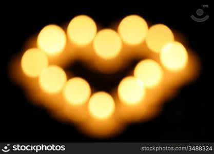 sacred candles in dark on black background