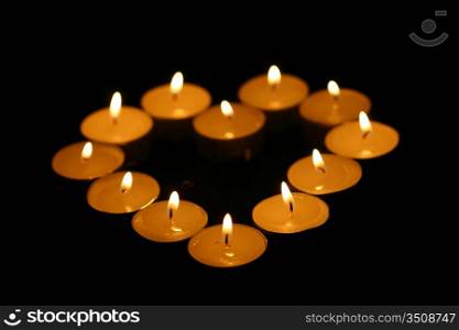 sacred candles in dark on black background