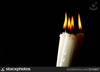 sacred candles in dark on black background