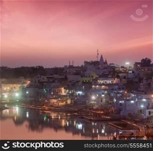 Sacred Puskhar lake (Sagar) and ghats of town Pushkar in twilight in the evening, Rajasthan, India