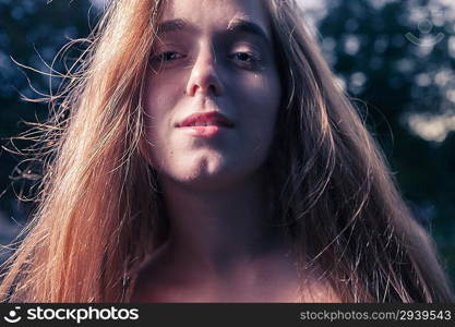 Sad 20s female outside very closeup shot. Portrait of a beautiful girl in the park in autumn season.