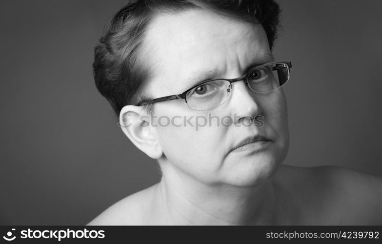 Sad 50 year old woman, close-up black and white image