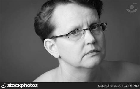 Sad 50 year old woman, close-up black and white image