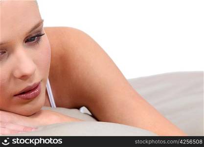 Sad blond woman in bed