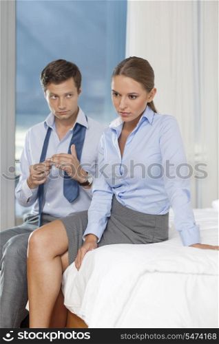 Sad business couple in hotel room