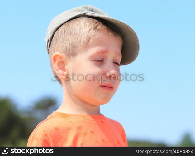 Sad child. Portrait of crying unhappy little boy outdoor