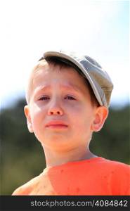 Sad child. Portrait of crying unhappy little boy outdoor