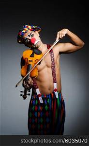 Sad clown performing at vioin