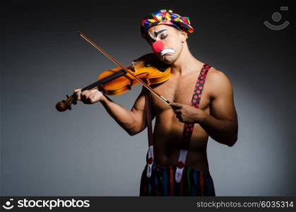Sad clown performing at vioin
