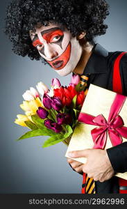 Sad clown with the flowers