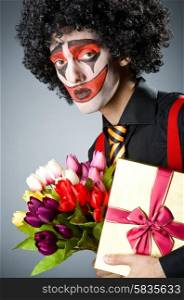 Sad clown with the flowers