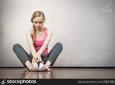 Sad depressed young teenage girl sitting by wall. School, adolescence, home violence, unwanted love problems.. Sad depressed young teenage girl sitting by wall