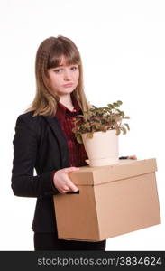 Sad girl fired from her job and holding a box with things. Portrait of a girl with box fired and flower in hands