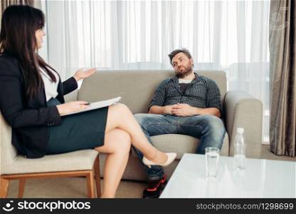 Sad hasband at psychologist, professional psychology support. Female doctor gives consultation to male patient. Sad hasband at psychologist, psychology support
