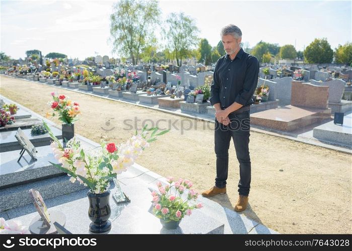 sad man in a graveyard