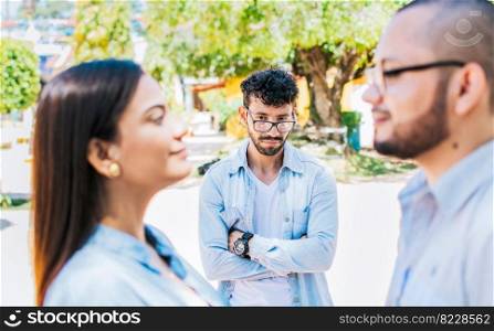 Sad man seeing his girlfriend cheating with his friend outdoors, Sad boyfriend seeing his girlfriend with another one outdoors. Man watching his girlfriend cheating with another man