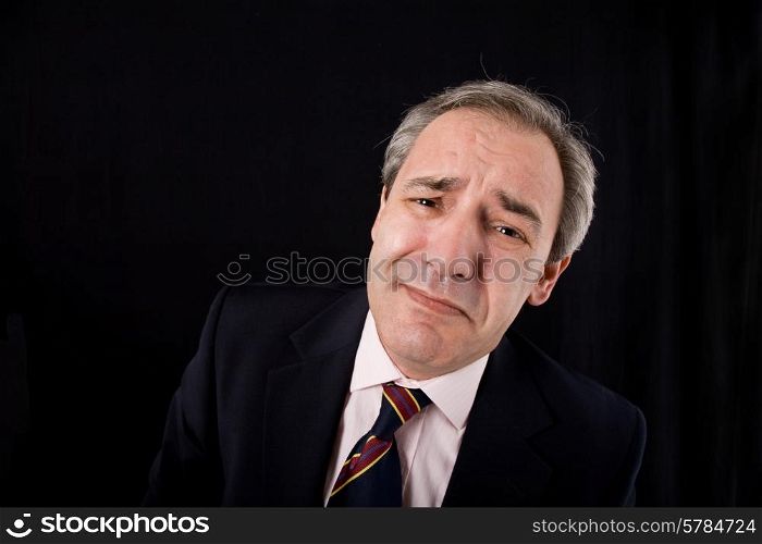 sad mature business man on a black background