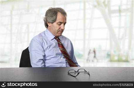 sad mature business man on a desk, at the office