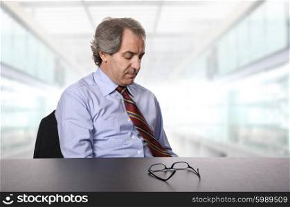 sad mature business man on a desk at the office