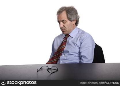 sad mature business man on a desk, isolated on white