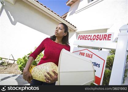 Sad mid adult woman moving out of house