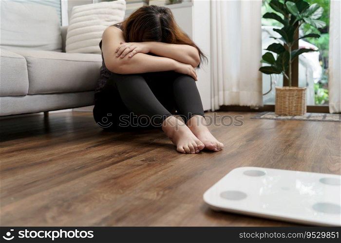 Sad obese woman with fat upset bored of dieting Weight loss fail  Fat diet and scale sad fat asian woman  weight scale at home weight control.