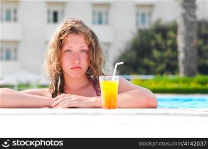 sad pretty bored woman is boring in the hotel swimming pool