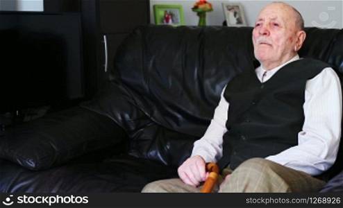 Sad senior man alone at home