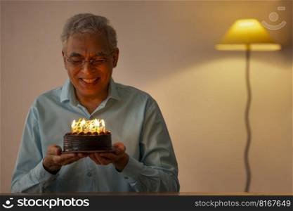 Sad senior man celebrating his birthday at home 