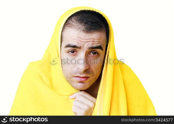 Sad sick man with fever in a yellow blanket