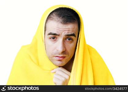 Sad sick man with fever in a yellow blanket