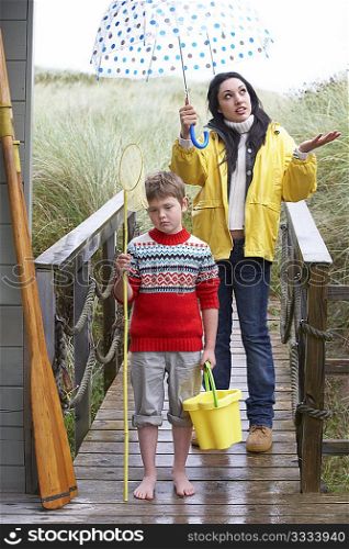 Sad woman and child with umbrella