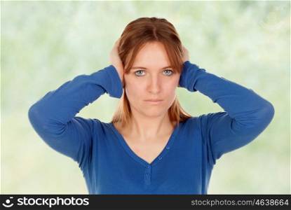 Sad woman covering her ears isolated on a white background