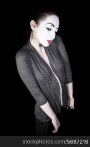 Sad woman mime in grey jacket on black background