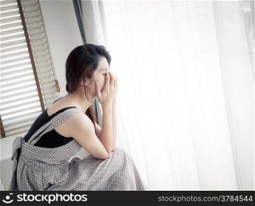 sad woman sitting alone in room