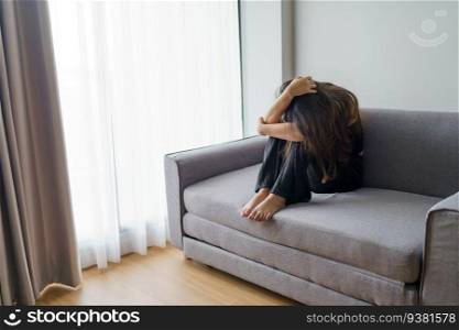 Sad woman thinking about problems sitting on a sofa upset girl feeling lonely and sad from bad relationship or Depressed woman disorder mental health