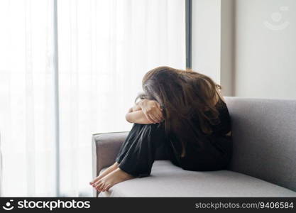 Sad woman thinking about problems sitting on a sofa upset girl feeling lonely and sad from bad relationship or Depressed woman disorder mental health