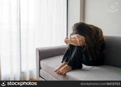 Sad woman thinking about problems sitting on a sofa upset girl feeling lonely and sad from bad relationship or Depressed woman disorder mental health