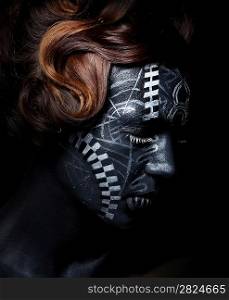 Sad woman with black painted face in carnival mask