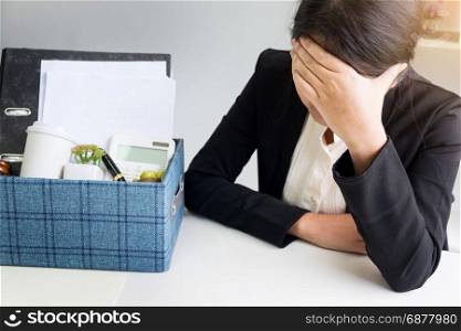 sadness pretty female office worker is fired packing personal belongings sitting on working desk feeling upset and thinking future job