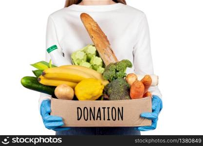 Safe food delivery or donation concept. Food delivery during coronavirus quarantine. Box with different food ingredients such as fruits, vegetables, milk, yogurt, eggs .. Safe food delivery or donation concept. Box with different food ingredients.