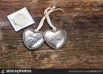 Safe love concept - two hearts with condom. Safe love concept