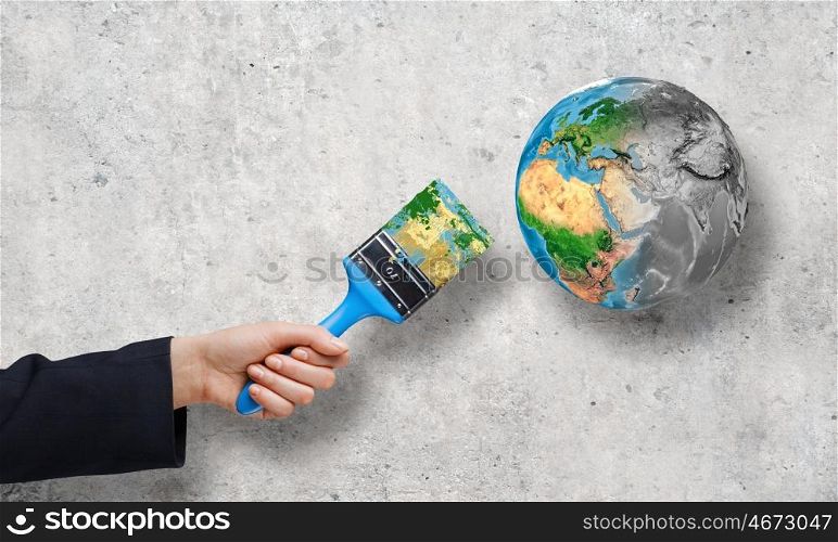 Safe our planet. Close up of business person hand painting Earth planet. Elements of this image are furnished by NASA
